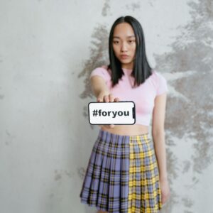 Woman in Pink Shirt and Blue Red and Yellow Plaid Skirt