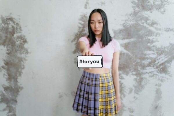 Woman in Pink Shirt and Blue Red and Yellow Plaid Skirt